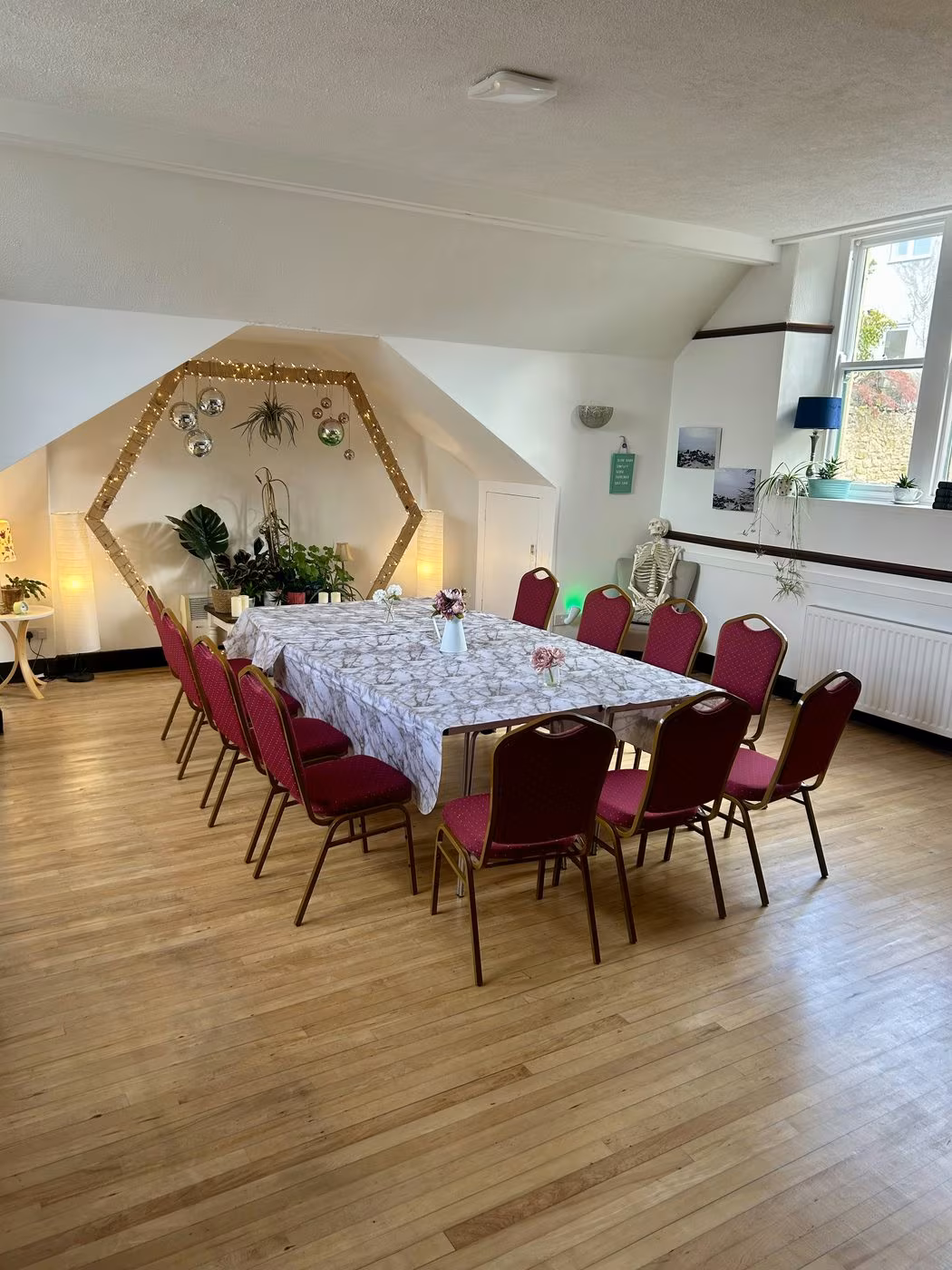 The hall at St Matthew's Wellness Centre set up with a table and chairs for a workshop or group event in Prudhoe